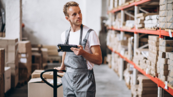 Young man working at a warehouse with boxes