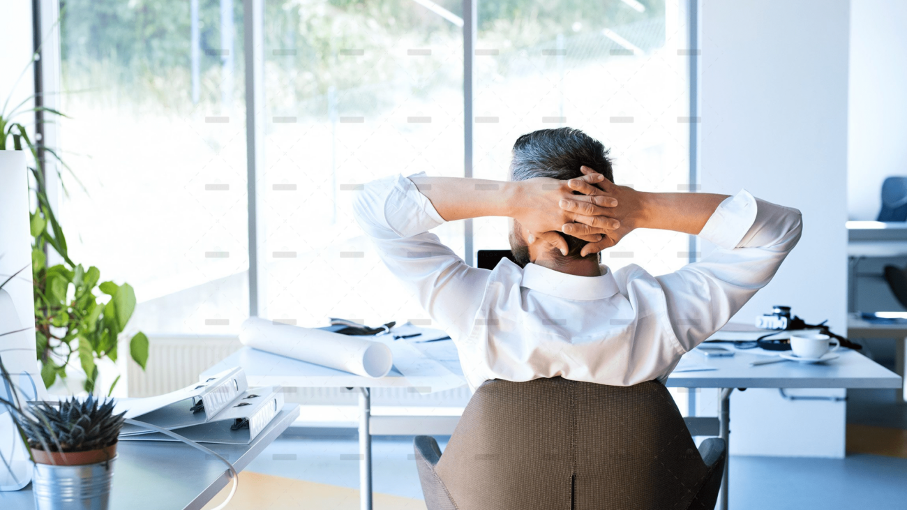 Businessman-at-the-desk-in-his-office-resting.