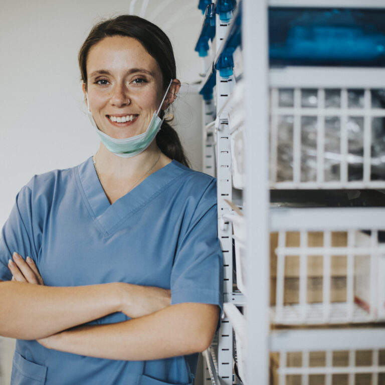 Happy nurse in a medical supplies room