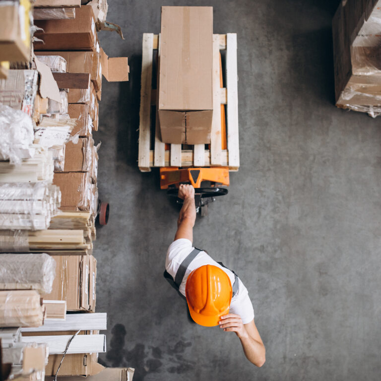 Young man working at a warehouse with boxes